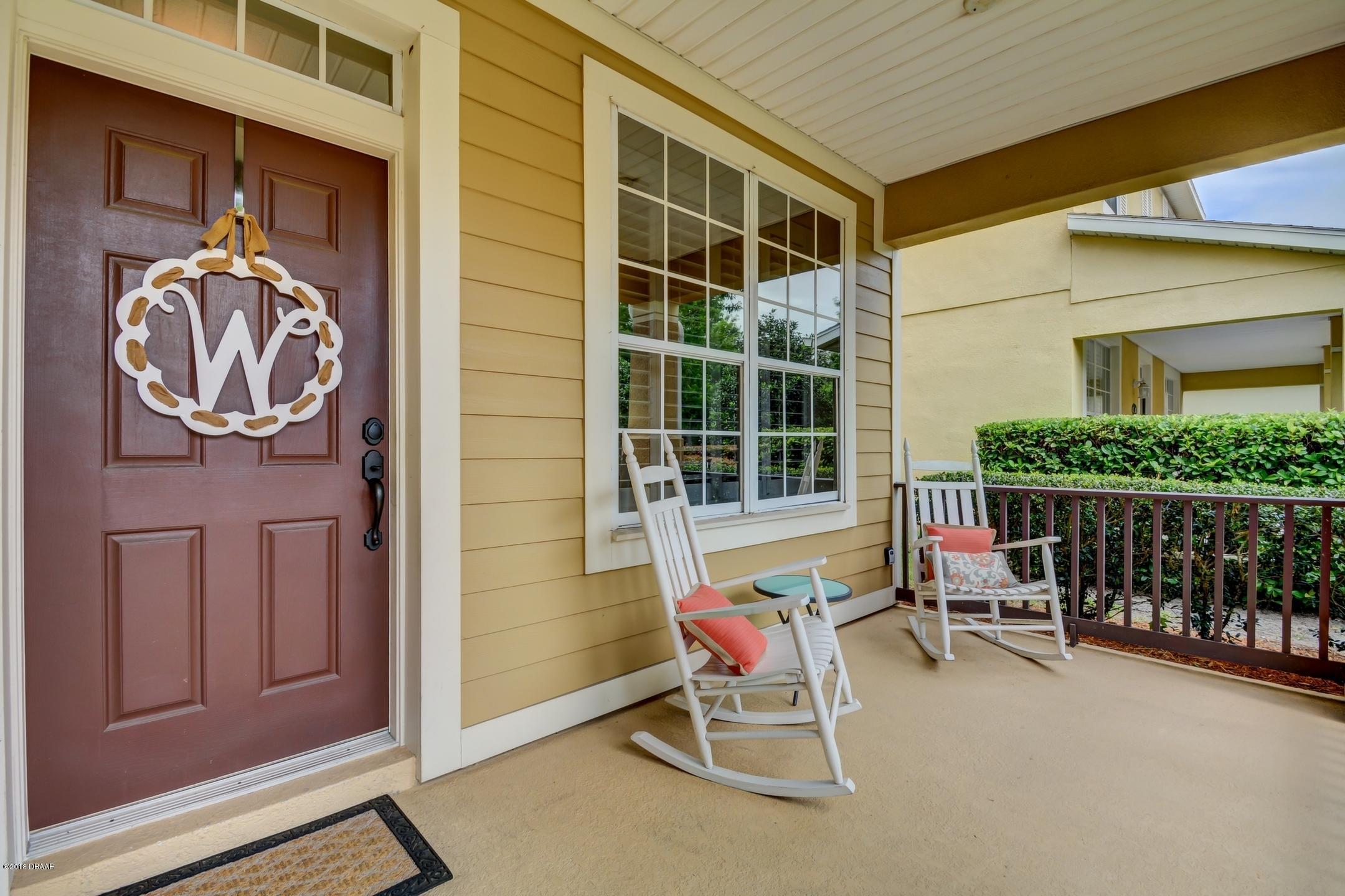 409 Manor View Lane DeLand, FL 32724 - Photo 2 of 31 a patio with table and chairs and potted plants
