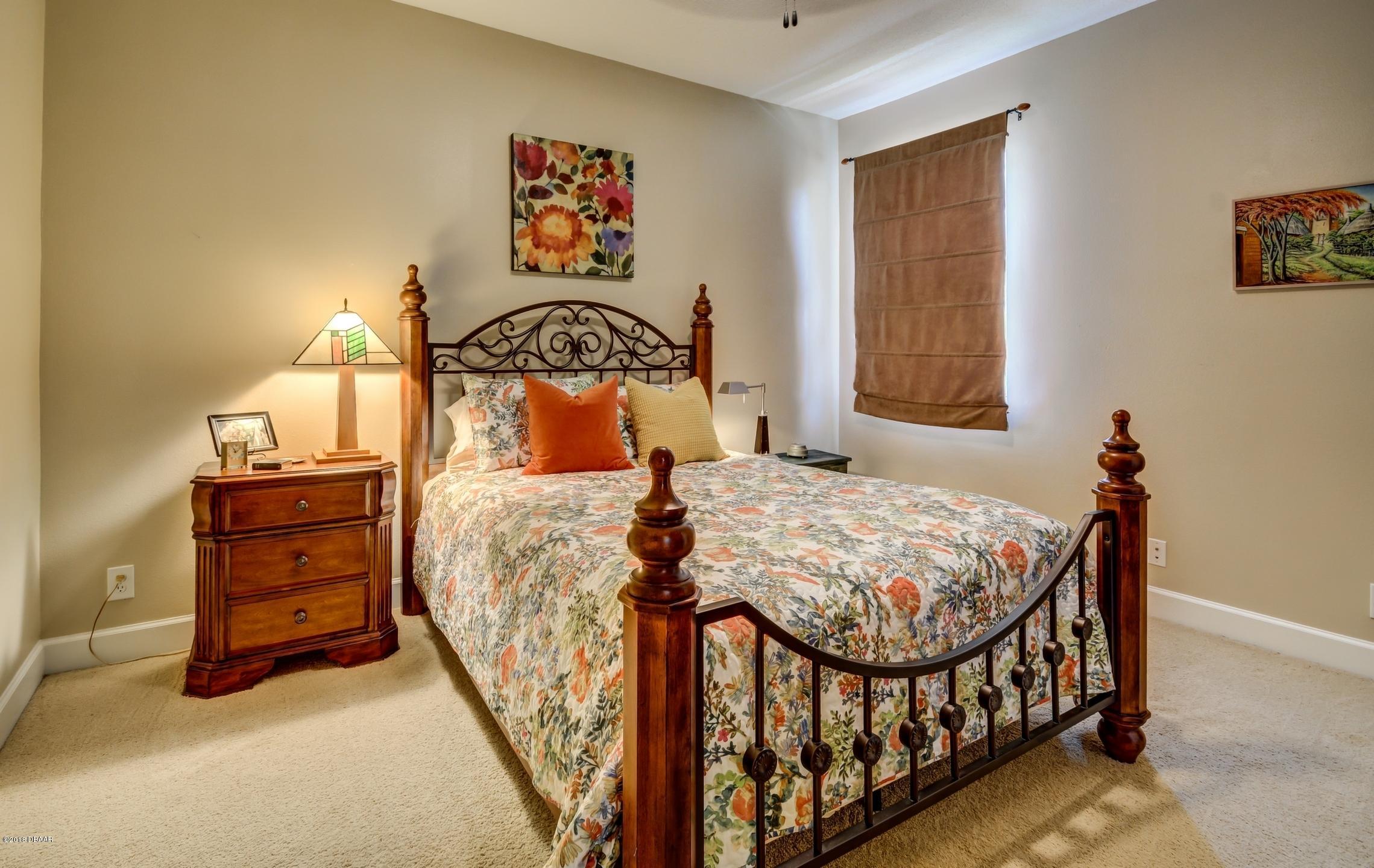409 Manor View Lane DeLand, FL 32724 - Photo 21 of 31 a bedroom with a bed and a window