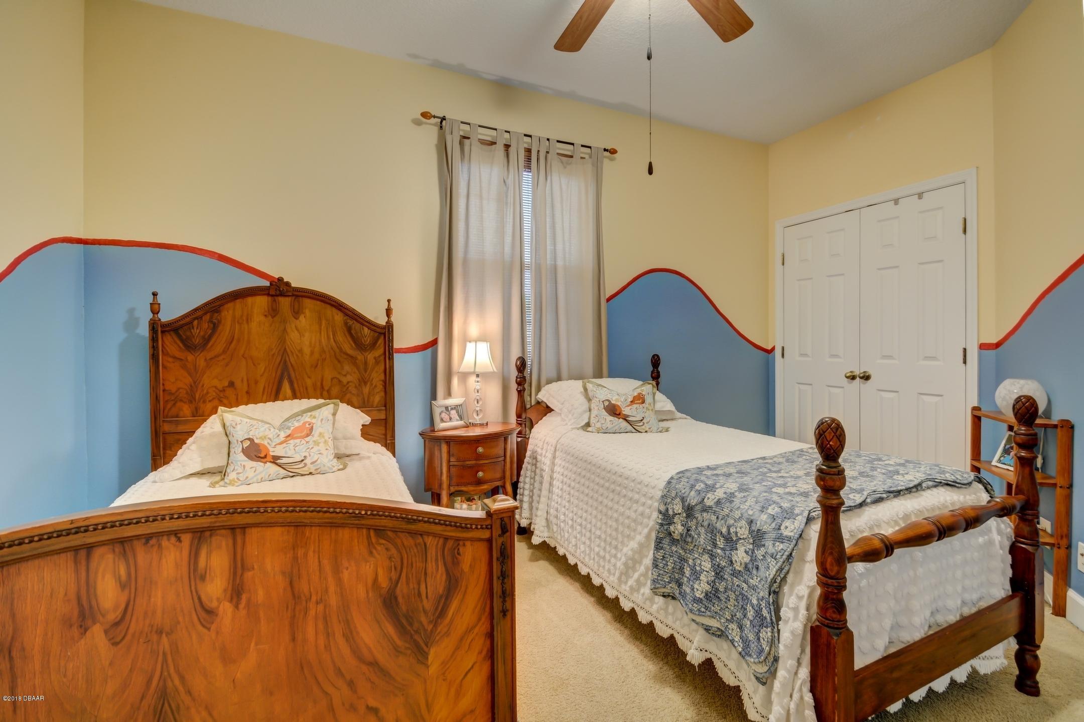 409 Manor View Lane DeLand, FL 32724 - Photo 22 of 31 a bedroom with a bed and window