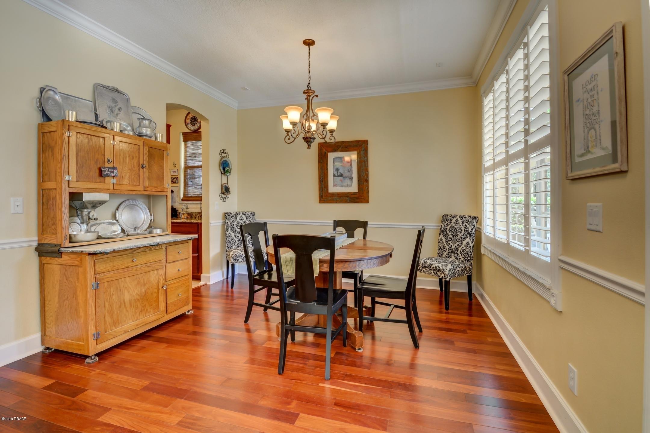 409 Manor View Lane DeLand, FL 32724 - Photo 6 of 31 a view of a dining room with furniture window and wooden floor