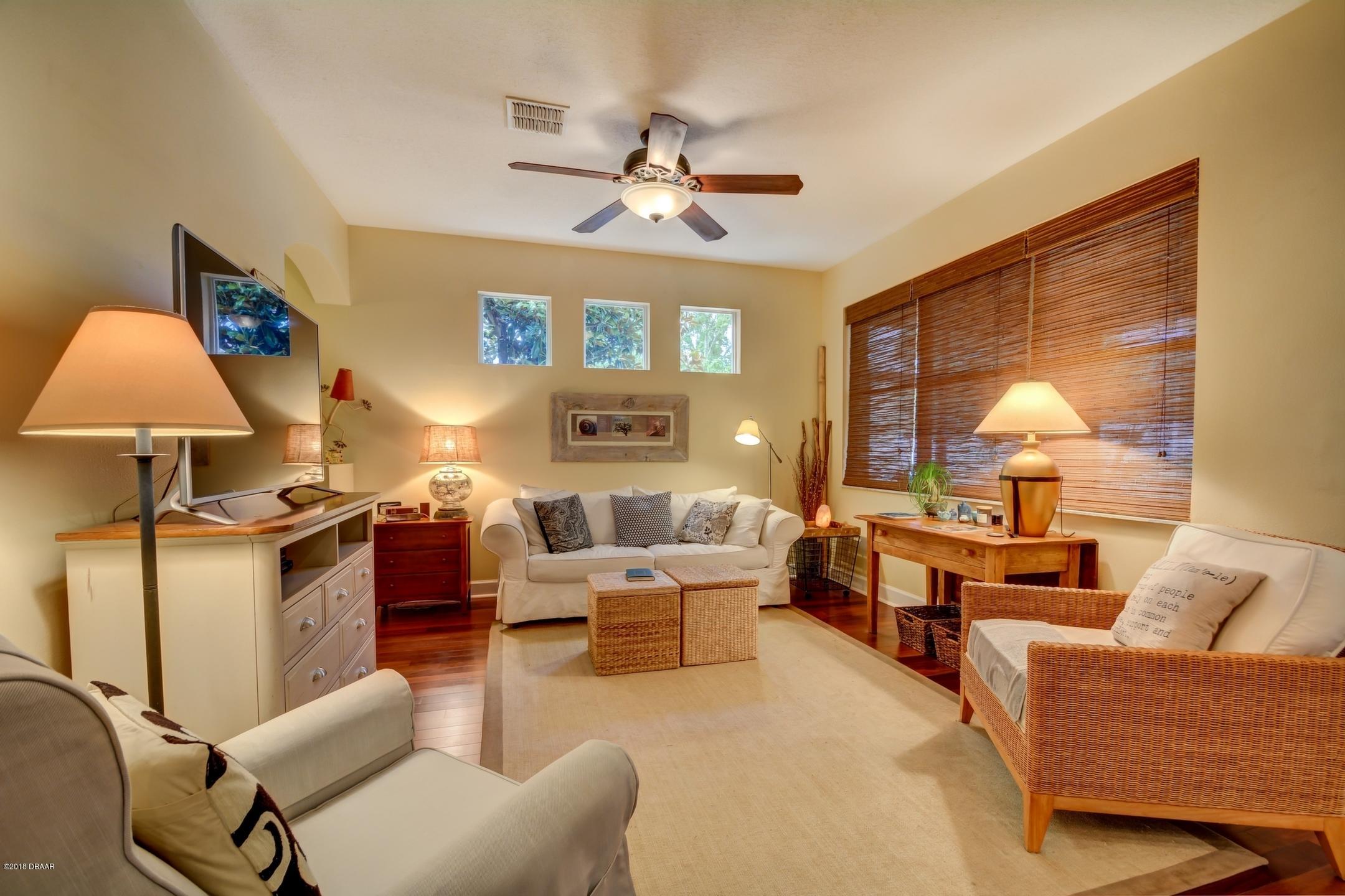 409 Manor View Lane DeLand, FL 32724 - Photo 8 of 31 a living room with furniture and a chandelier