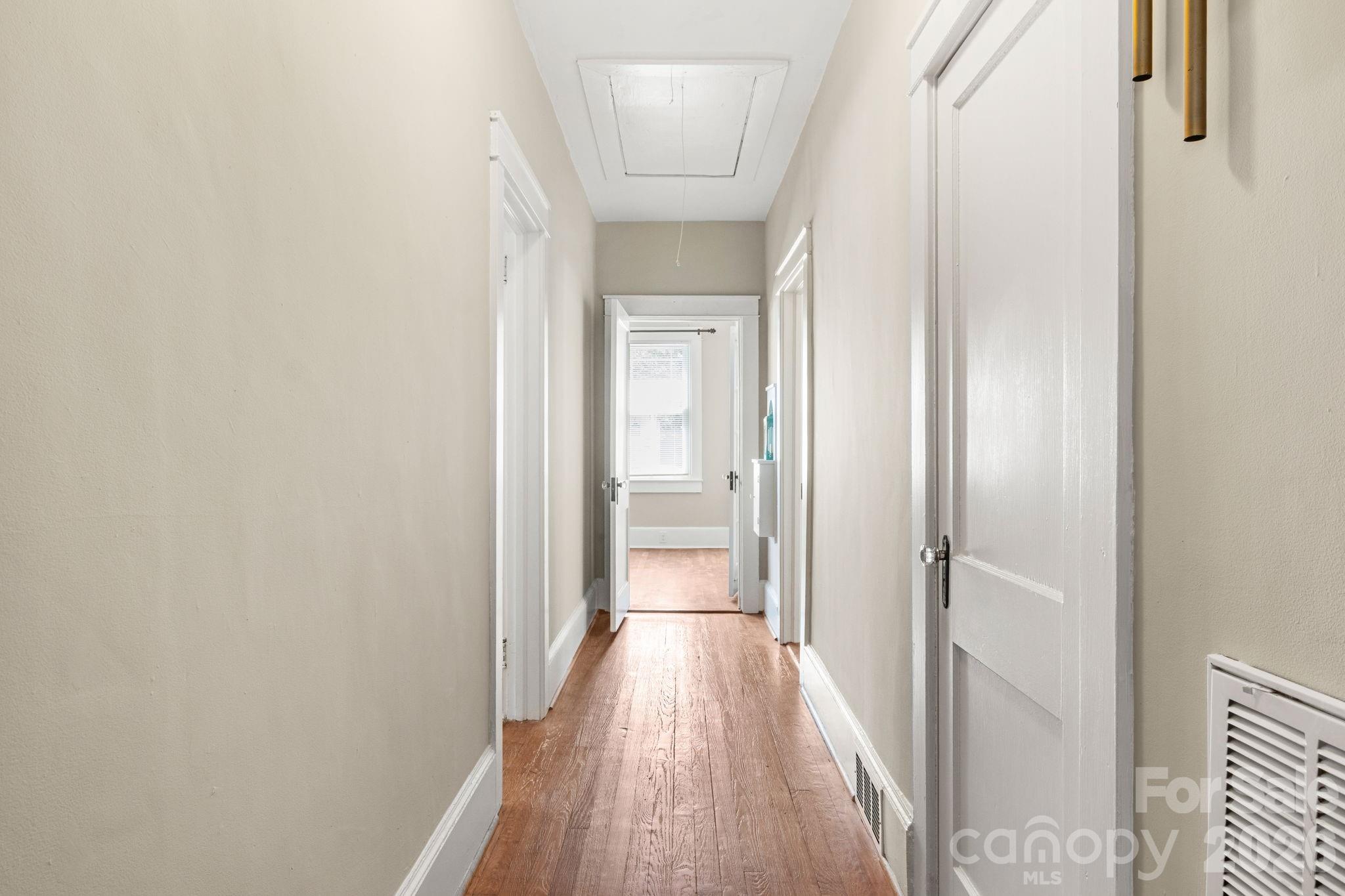 108 Reedy Street Chester, SC 29706 - Photo 28 of 42 a view of a hallway with wooden floor and a bathroom