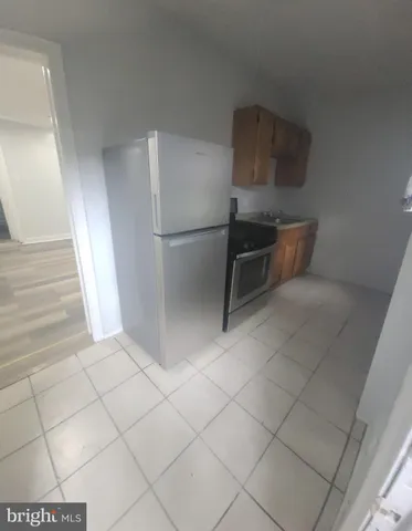 a kitchen with a sink and a refrigerator