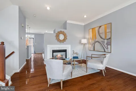 a living room with furniture a fireplace and a large window
