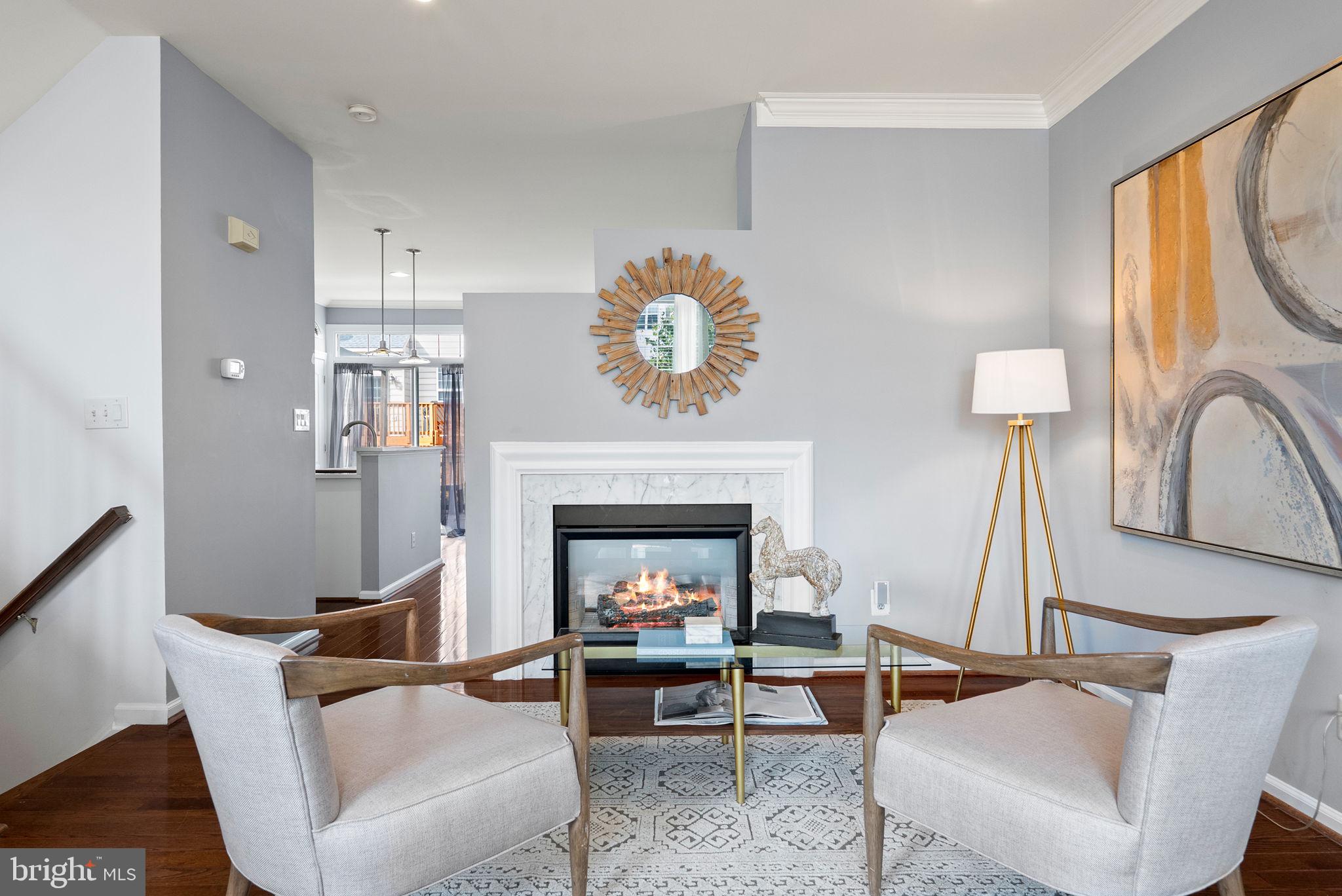 13368 Ferry Landing Lane Woodbridge, VA 22191 - Photo 13 of 44 a living room with furniture a fireplace and a large window