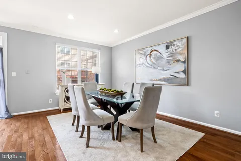 a kitchen with kitchen island a counter top space a sink stainless steel appliances and cabinets