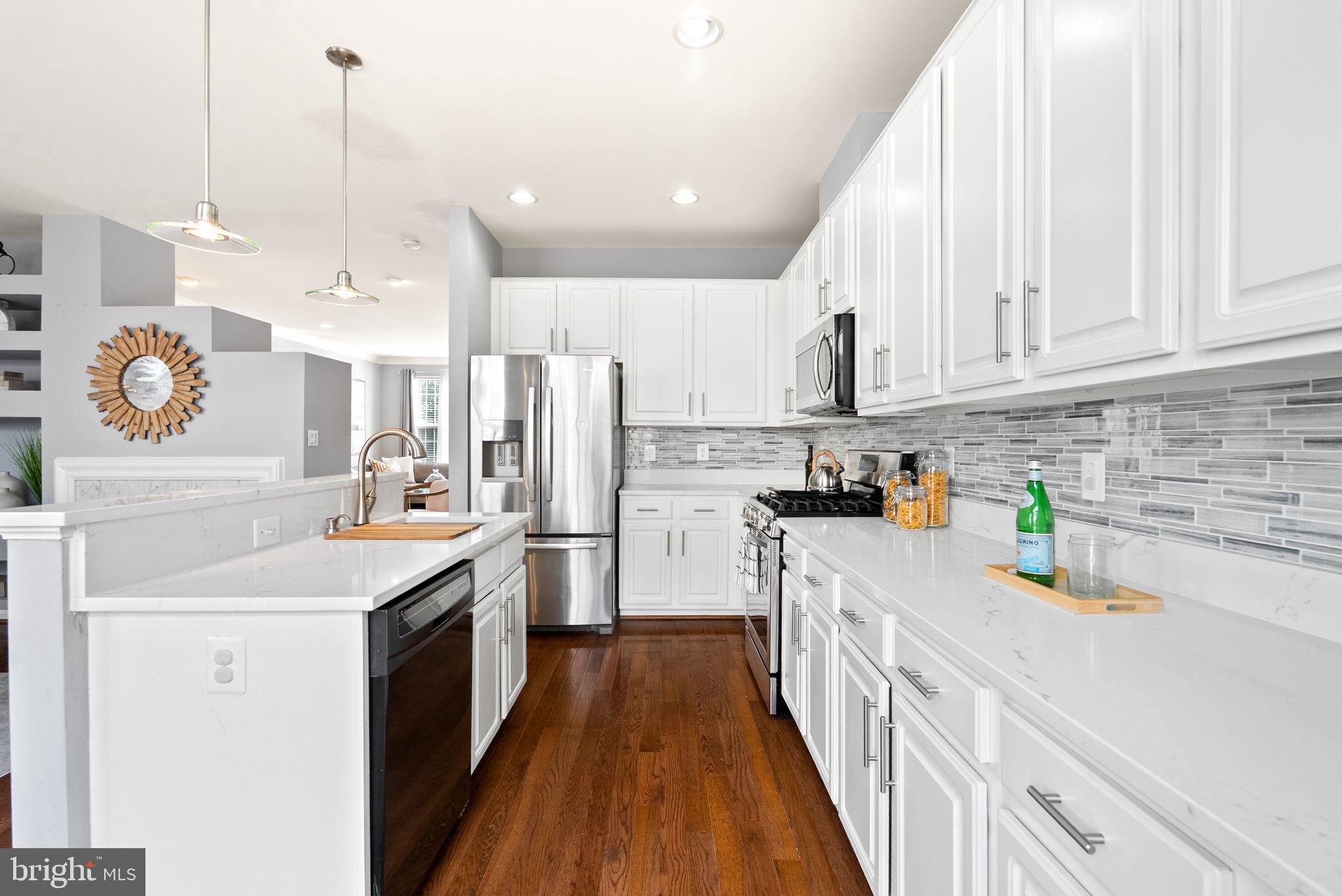 13368 Ferry Landing Lane Woodbridge, VA 22191 - Photo 17 of 44 a kitchen with stainless steel appliances sink stove top oven and cabinets