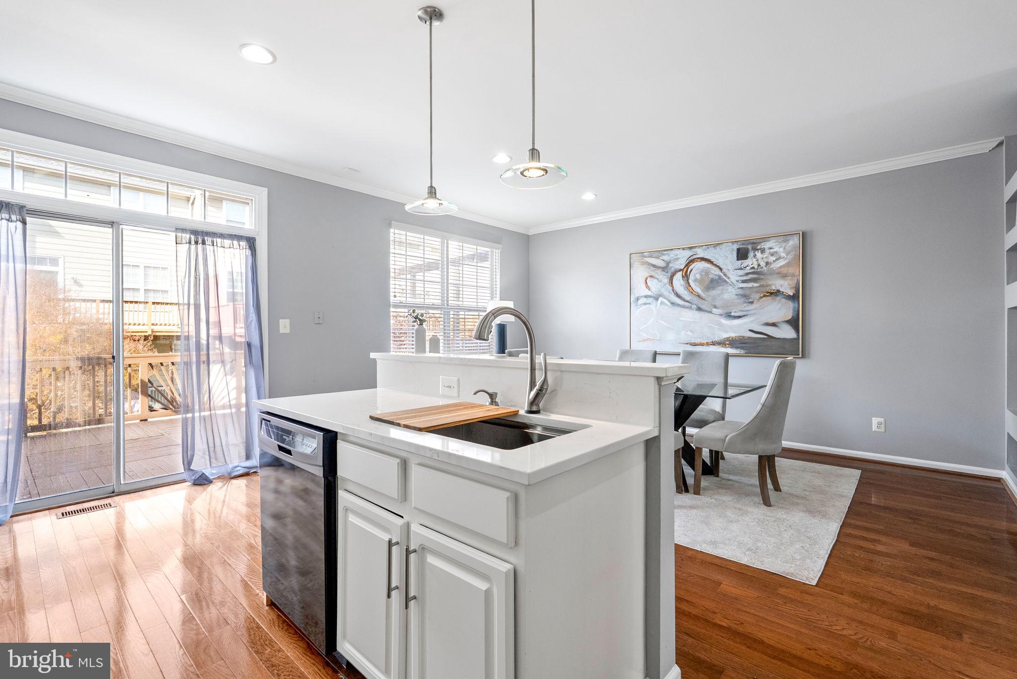 13368 Ferry Landing Lane Woodbridge, VA 22191 - Photo 18 of 44 a view of kitchen island a sink and a wooden floor