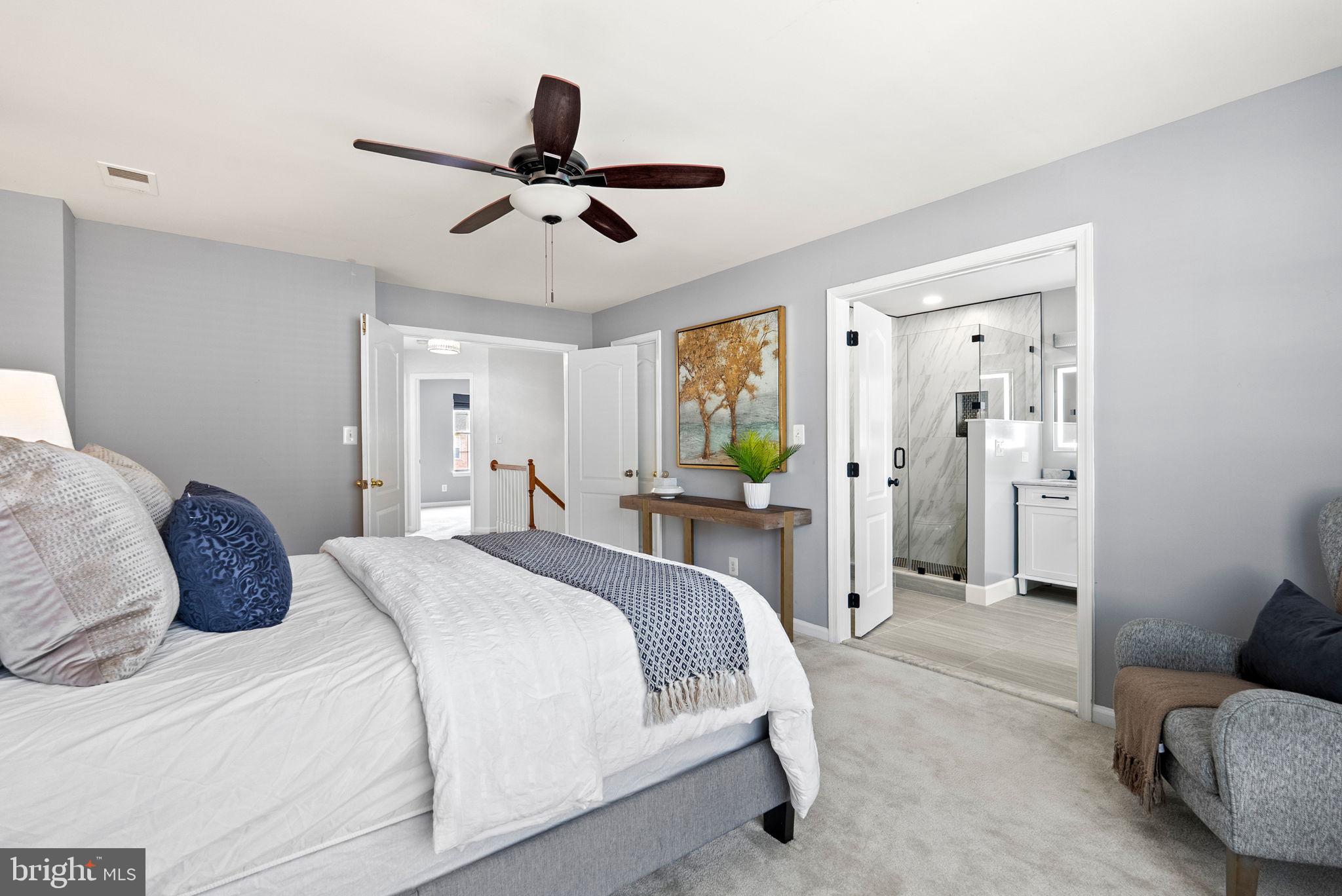 13368 Ferry Landing Lane Woodbridge, VA 22191 - Photo 22 of 44 a spacious bedroom with a bed and ceiling fan