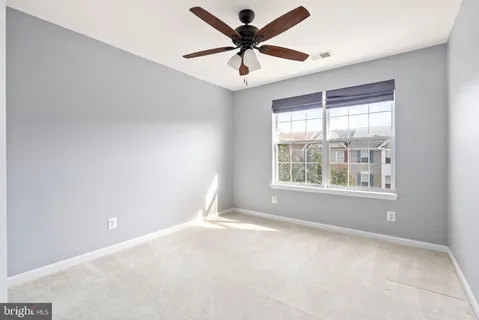 a view of room with a ceiling fan and a chandelier fan