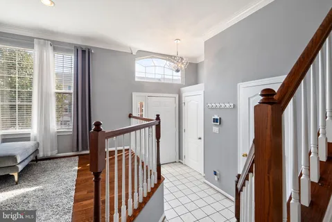 a living room with fireplace furniture and a rug