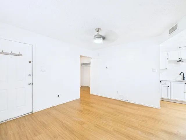a view of a room with wooden floor