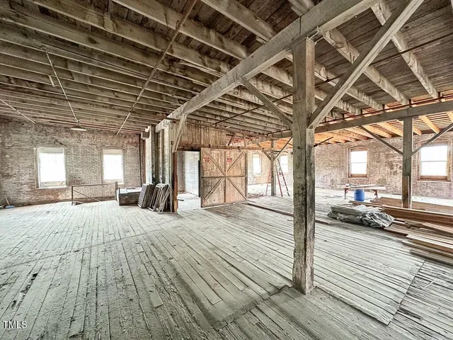 a view of a room with wooden floor