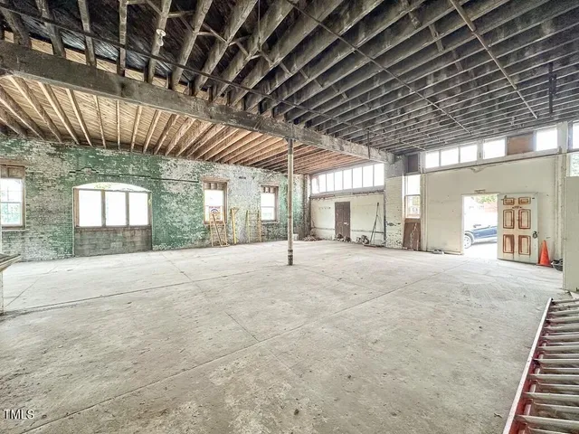 a view of an empty room with a fireplace