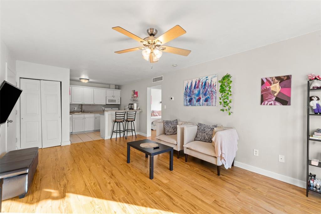 1700 Southwest 16th Court, Unit D30 Gainesville, FL 32608 - Photo 4 of 22 a living room with stainless steel appliances kitchen island granite countertop furniture and a flat screen tv