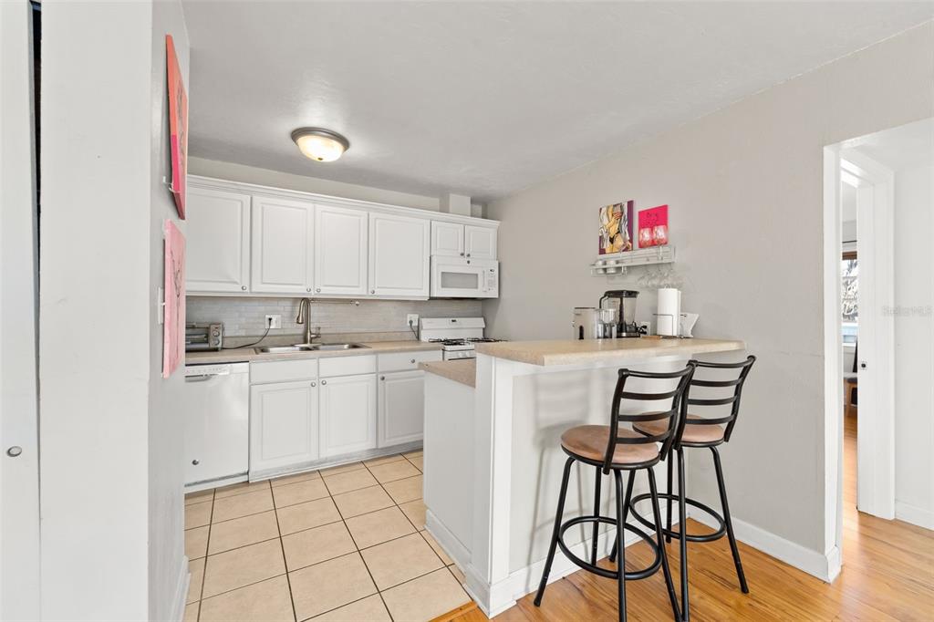 1700 Southwest 16th Court, Unit D30 Gainesville, FL 32608 - Photo 7 of 22 a kitchen with a sink cabinets and window