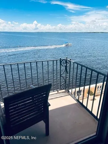 a view of roof deck with open kitchen view and ocean view