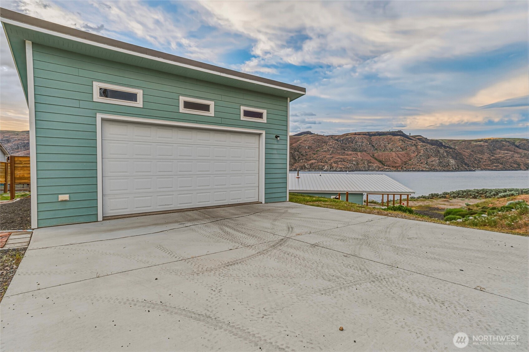 4205 Plum Point Road Grand Coulee, WA 99133 - Photo 31 of 39 a view of a house with a yard and garage