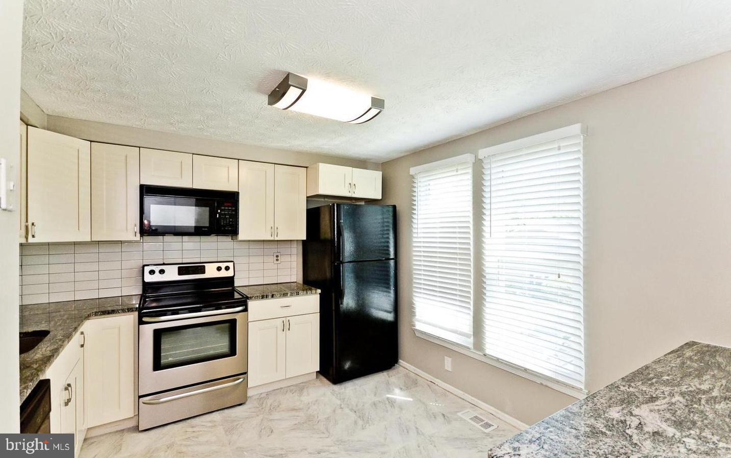 15781 Haynes Road Laurel, MD 20707 - Photo 14 of 34 Modern kitchen with natural light.