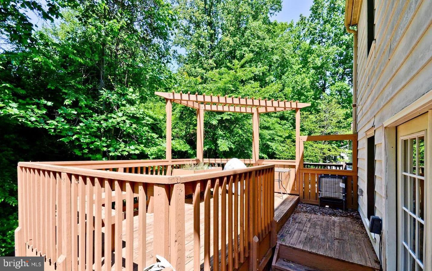 15781 Haynes Road Laurel, MD 20707 - Photo 32 of 34 Serene deck surrounded by lush greenery.