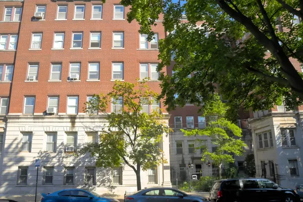 a front view of a building with a garden