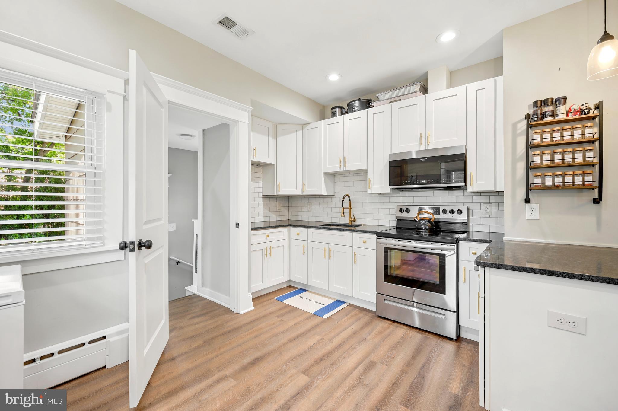 211 North Sylvania Avenue Jenkintown, PA 19046 - Photo 3 of 17 a kitchen with stainless steel appliances white cabinets a sink a stove a refrigerator and microwave