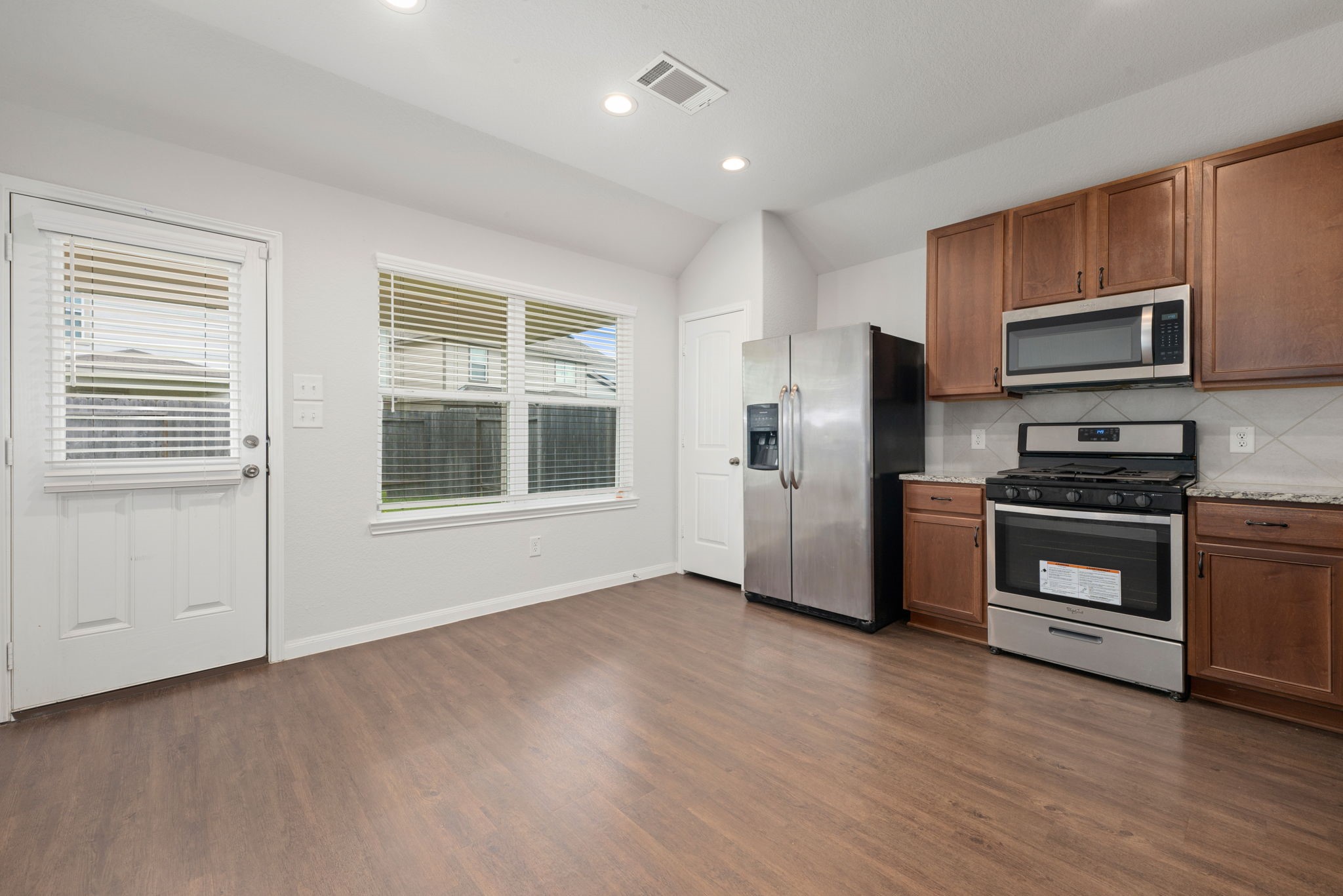 17555 Greystanes Road Humble, TX 77346 - Photo 5 of 28 a kitchen with stainless steel appliances a refrigerator and a stove top oven