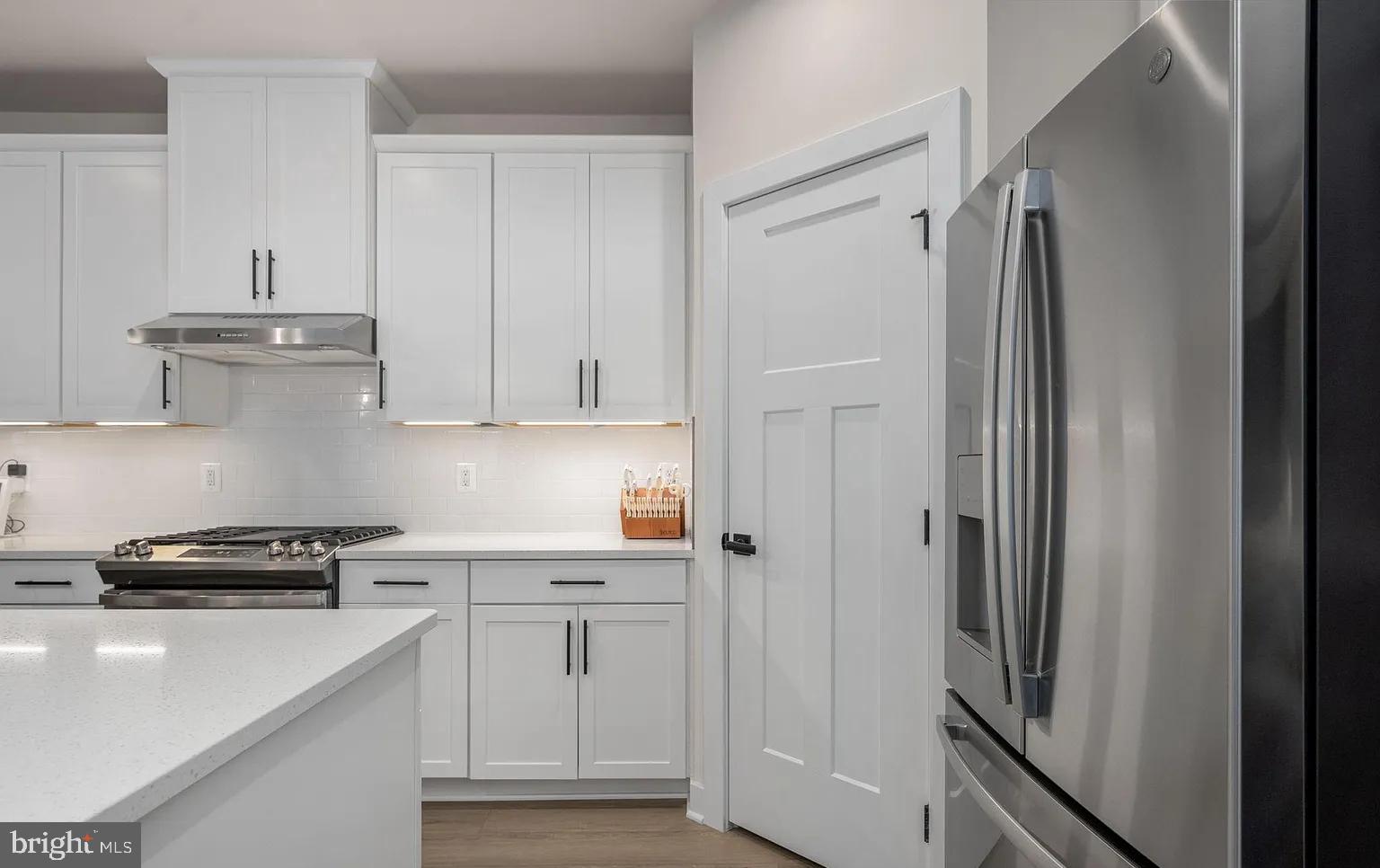 202 Grisham Road Stafford, VA 22554 - Photo 14 of 63 a kitchen with white cabinets and refrigerator
