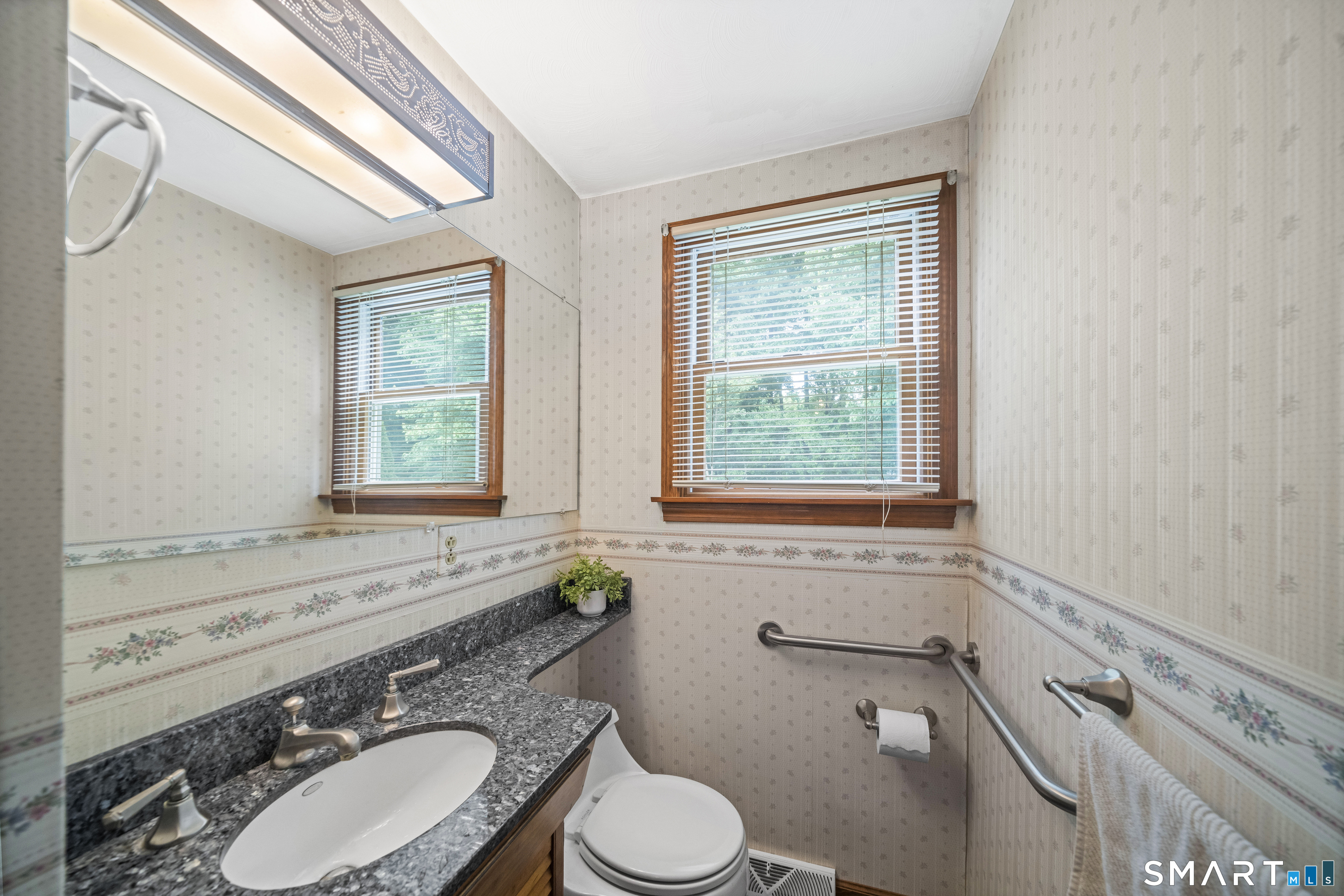 6 Cartier Road Enfield, CT 06082 - Photo 16 of 40 a bathroom with a granite countertop toilet a sink and a window