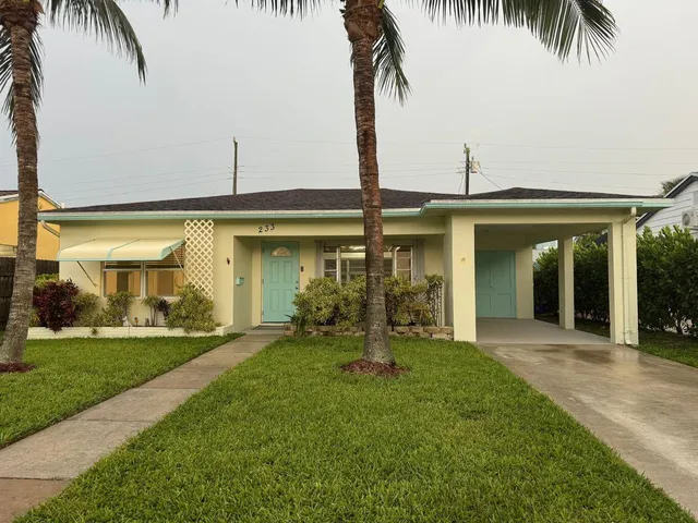 a front view of a house with a yard and porch