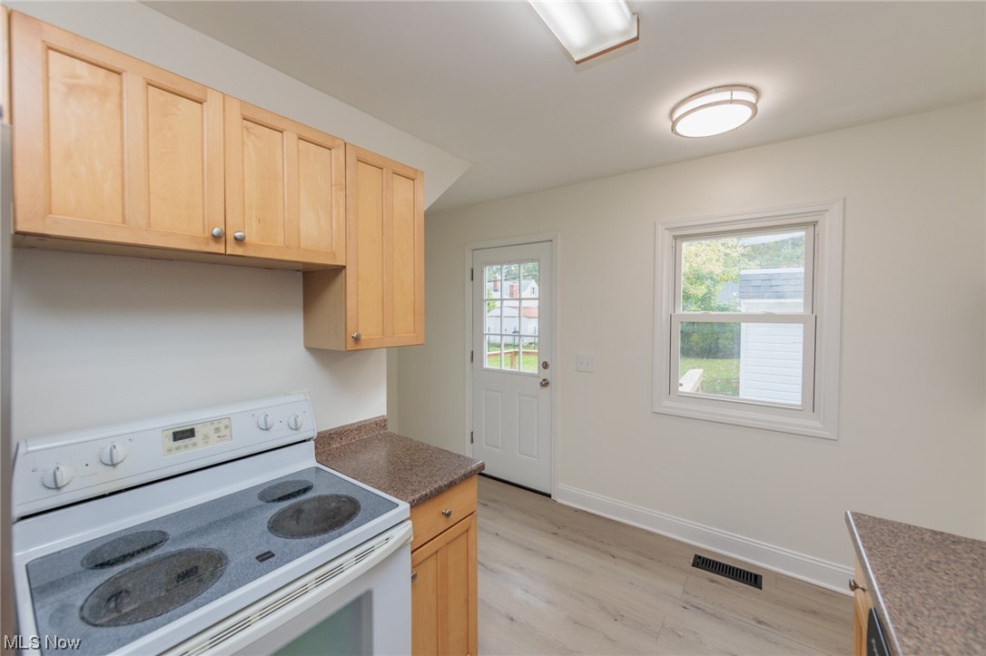 355 Dellwood Road Avon Lake, OH 44012 - Photo 16 of 35 Kitchen with white range oven, light hardwood floors, and light brown cabinets