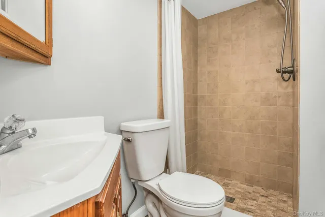 a white toilet sitting next to a bathroom sink