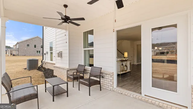 a living room with furniture a mirror and a fireplace