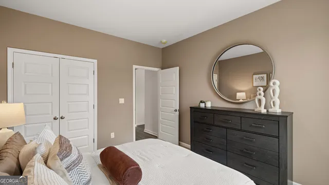 a spacious bedroom with a large bed and a chandelier