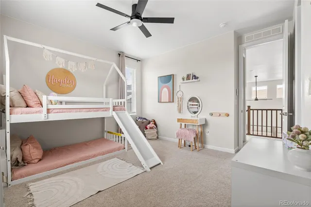 a view of a hallway to a livingroom with furniture and windows