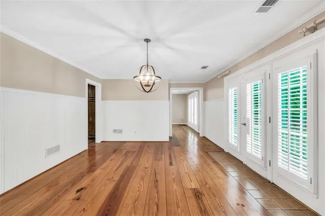 a kitchen with stainless steel appliances granite countertop a stove a sink dishwasher a microwave oven and a refrigerator with wooden floor