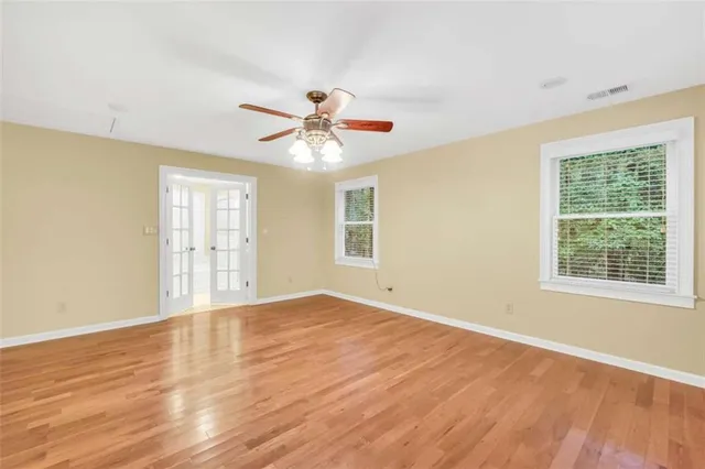 a view of a hallway with wooden floor and entryway