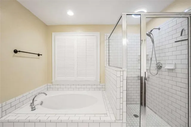 a bathroom with a bathtub and a shower