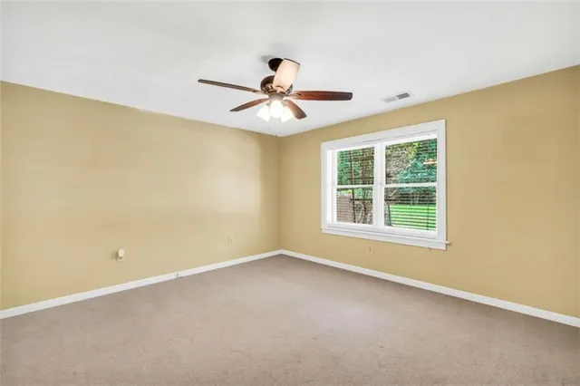 a view of a livingroom with a floor to ceiling window and chandelier