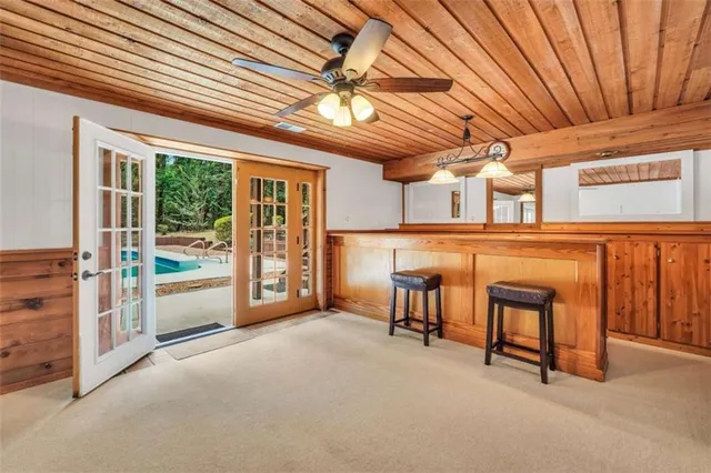 an empty room with a ceiling fan and a window