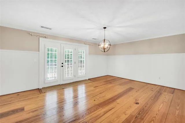 a view of a room with wooden floor and window