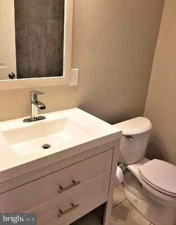 a bathroom with a sink a toilet and mirror