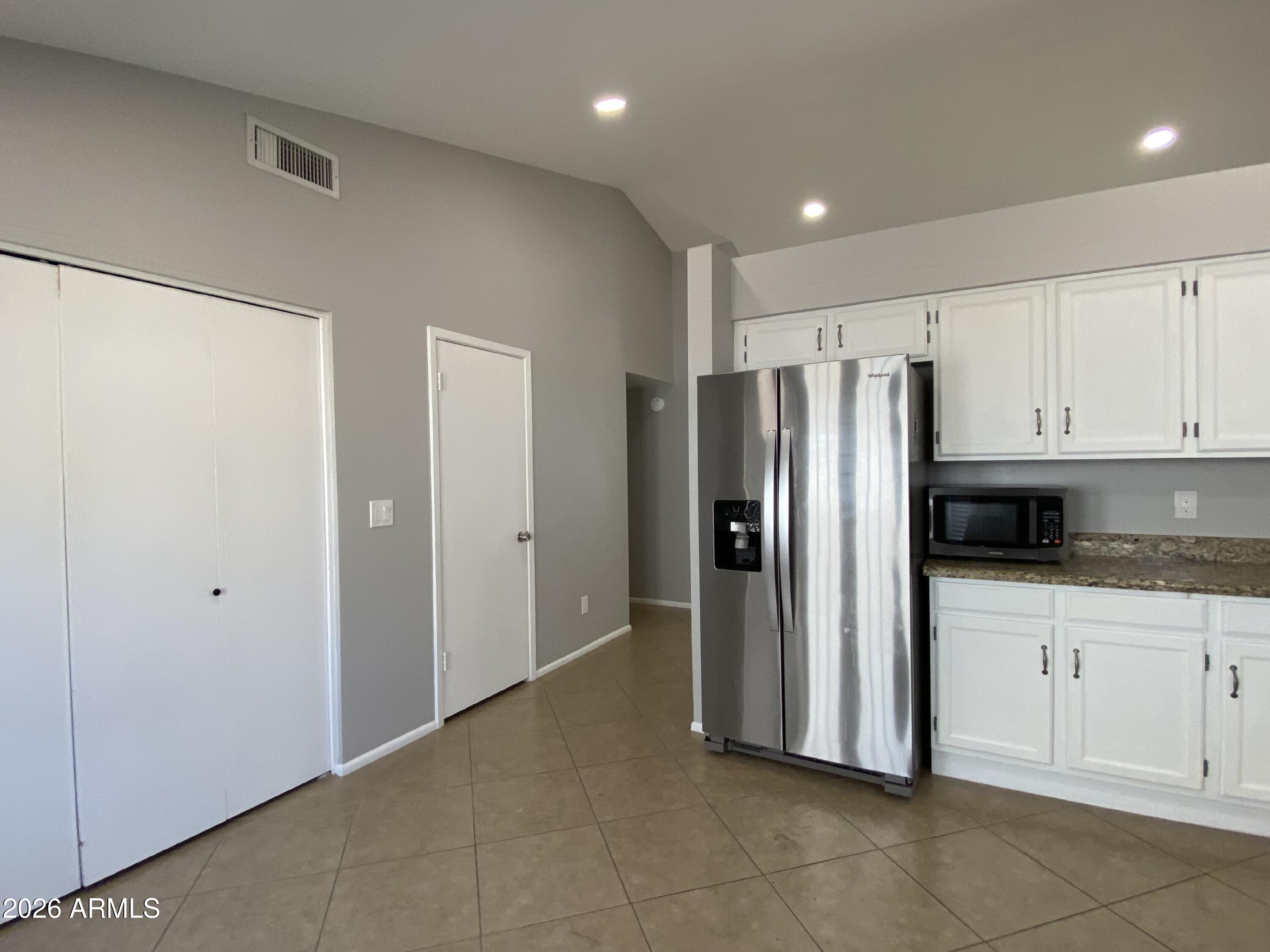 1055 North Recker Road, Unit 1196 Mesa, AZ 85205 - Photo 13 of 42 a kitchen with stainless steel appliances granite countertop a refrigerator and a sink