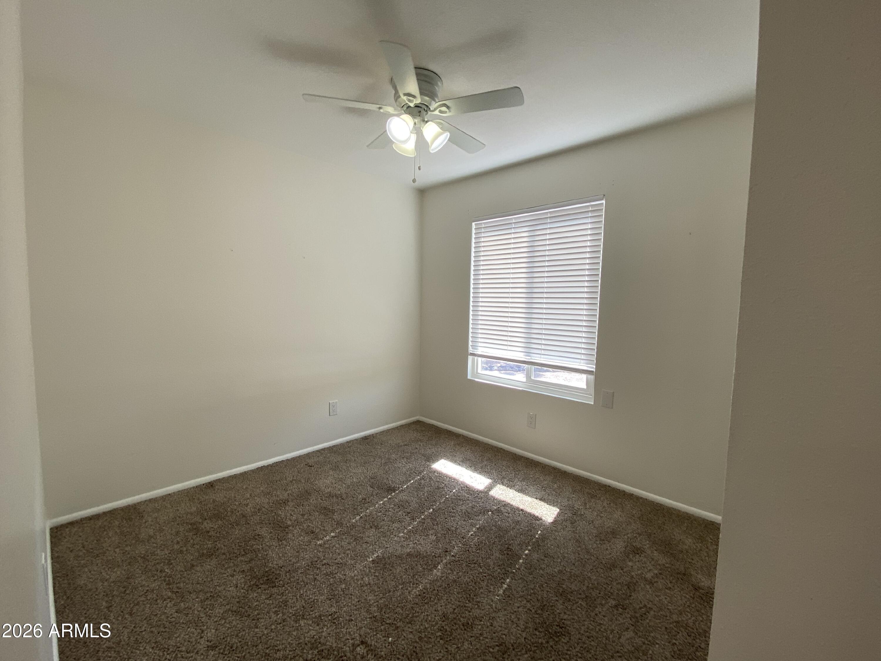1055 North Recker Road, Unit 1196 Mesa, AZ 85205 - Photo 25 of 42 a view of an empty room with a window