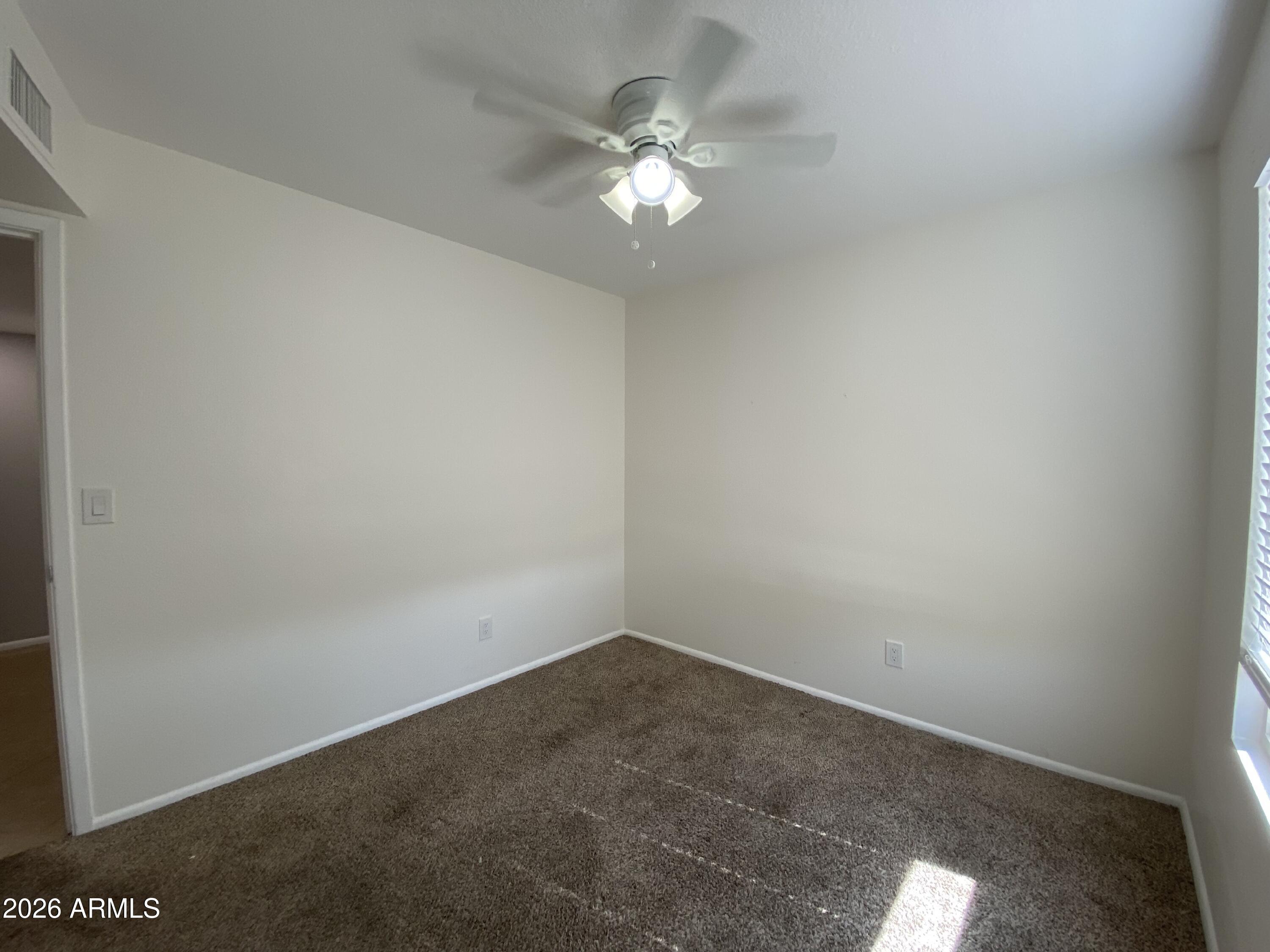 1055 North Recker Road, Unit 1196 Mesa, AZ 85205 - Photo 32 of 42 a view of a room with a fan
