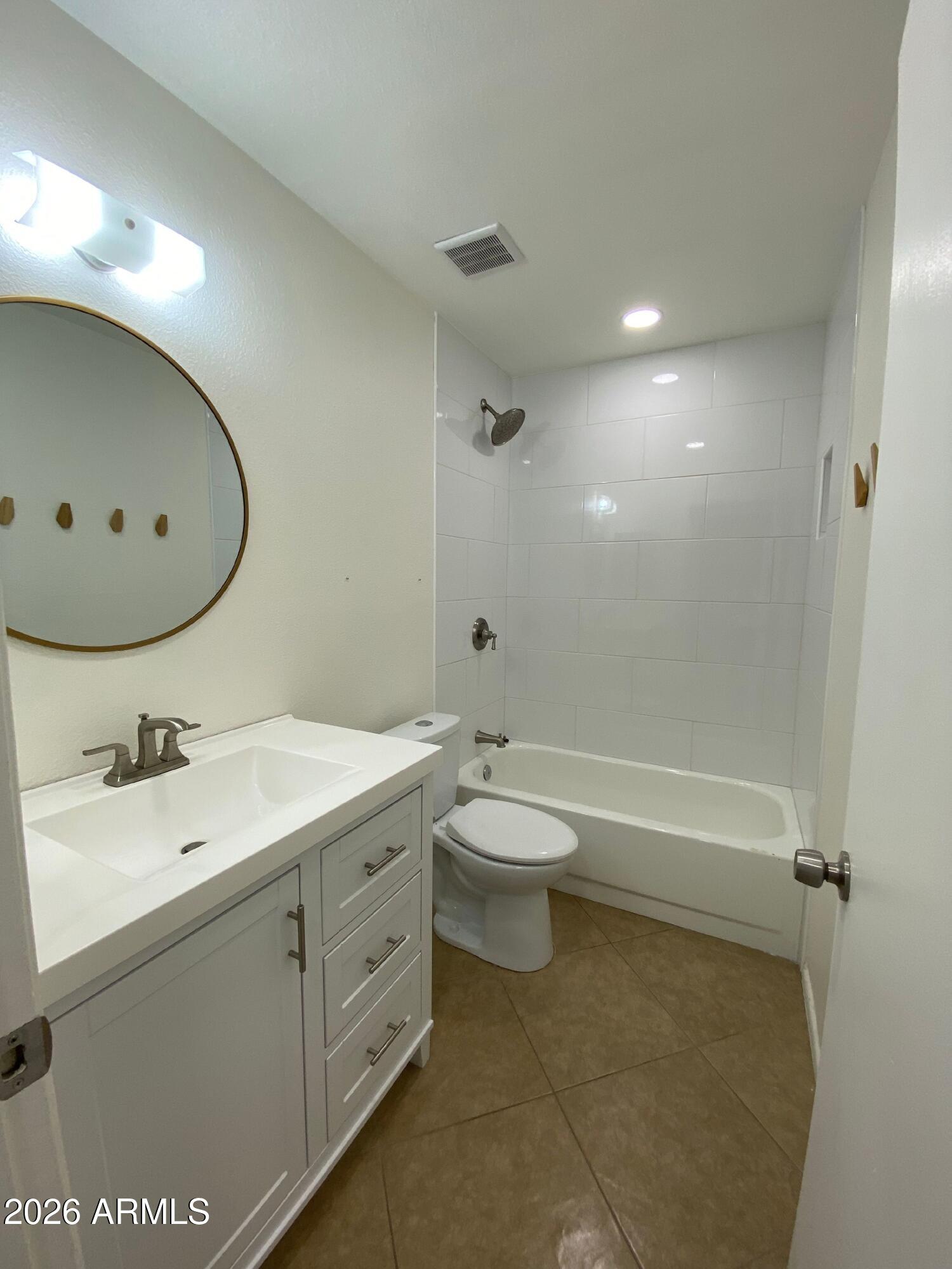1055 North Recker Road, Unit 1196 Mesa, AZ 85205 - Photo 33 of 42 a bathroom with a toilet sink and mirror