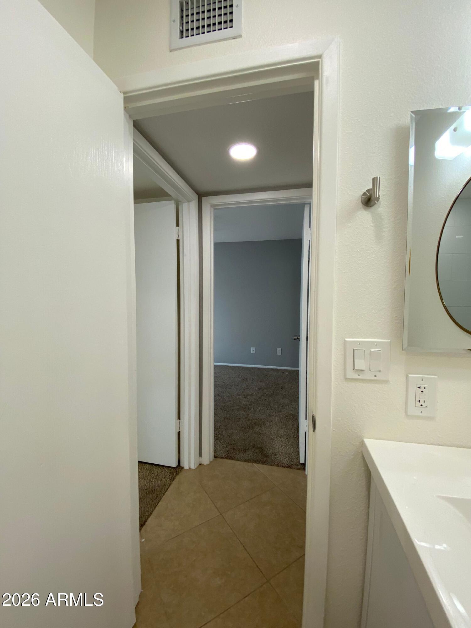 1055 North Recker Road, Unit 1196 Mesa, AZ 85205 - Photo 34 of 42 a bathroom with a sink a vanity and a mirror