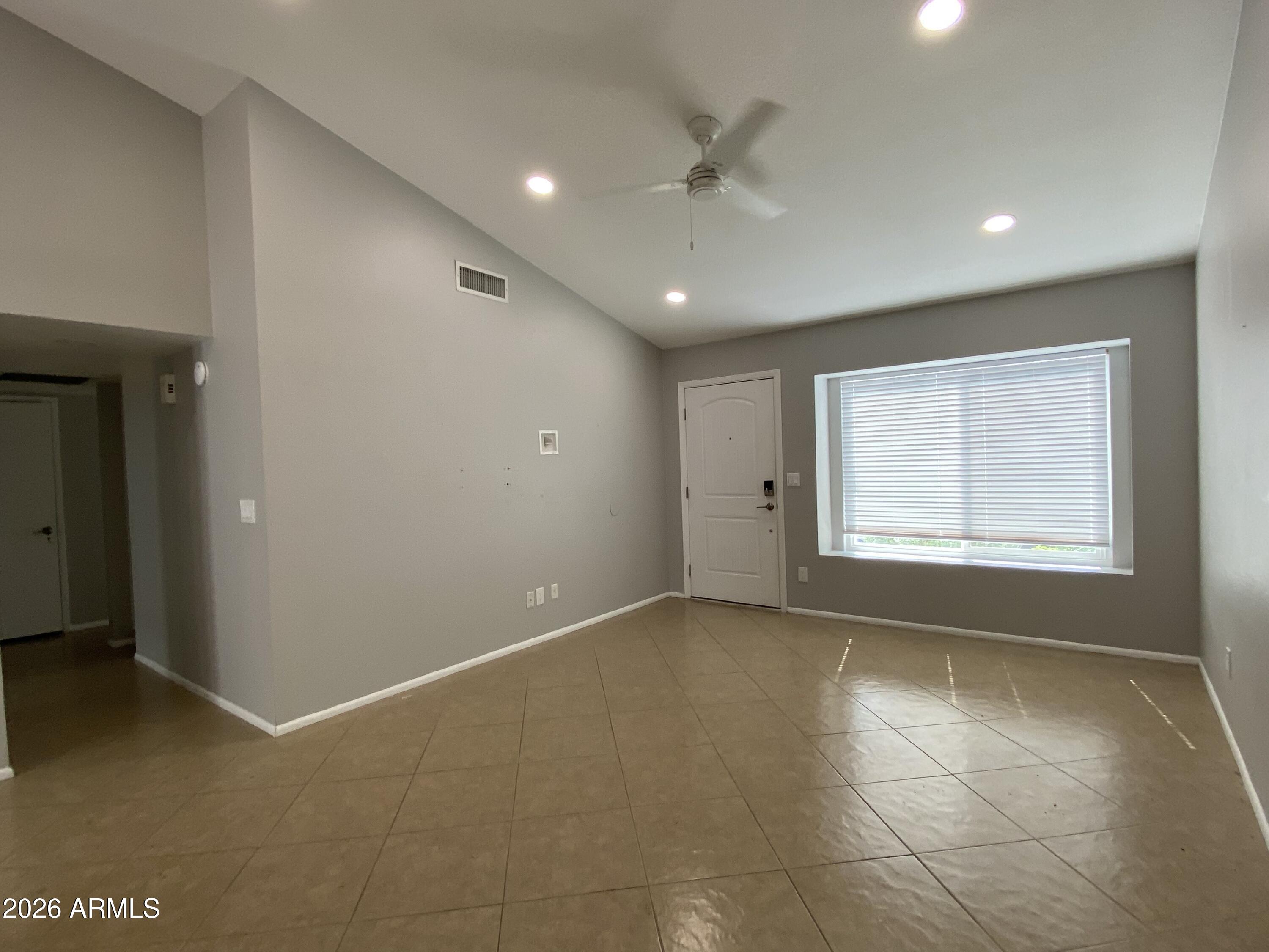 1055 North Recker Road, Unit 1196 Mesa, AZ 85205 - Photo 7 of 42 a view of an empty room with a window