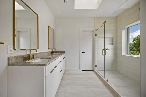 a bathroom with a double vanity sink and mirror