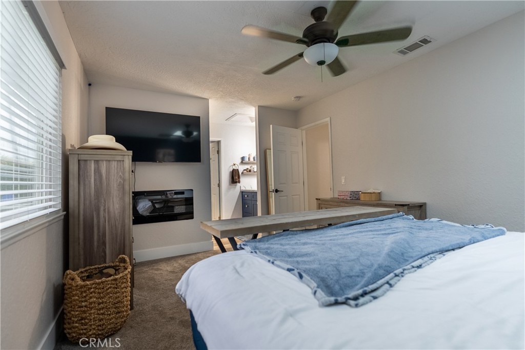 10328 Ivy Court Rancho Cucamonga, CA 91730 - Photo 17 of 40 a spacious bedroom with a bed a flat screen tv and dresser